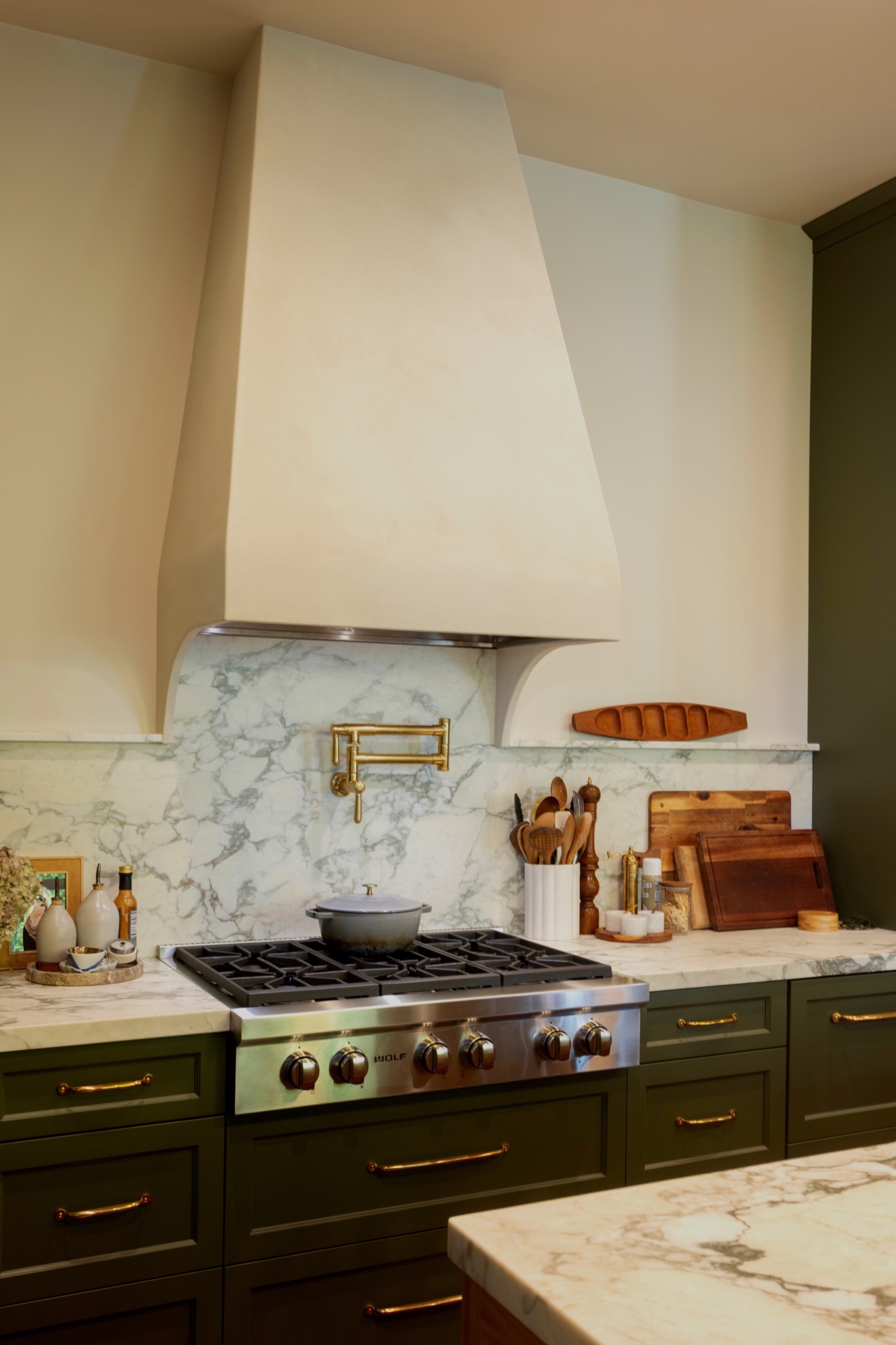 Custom plaster range hood and marble kitchen detail