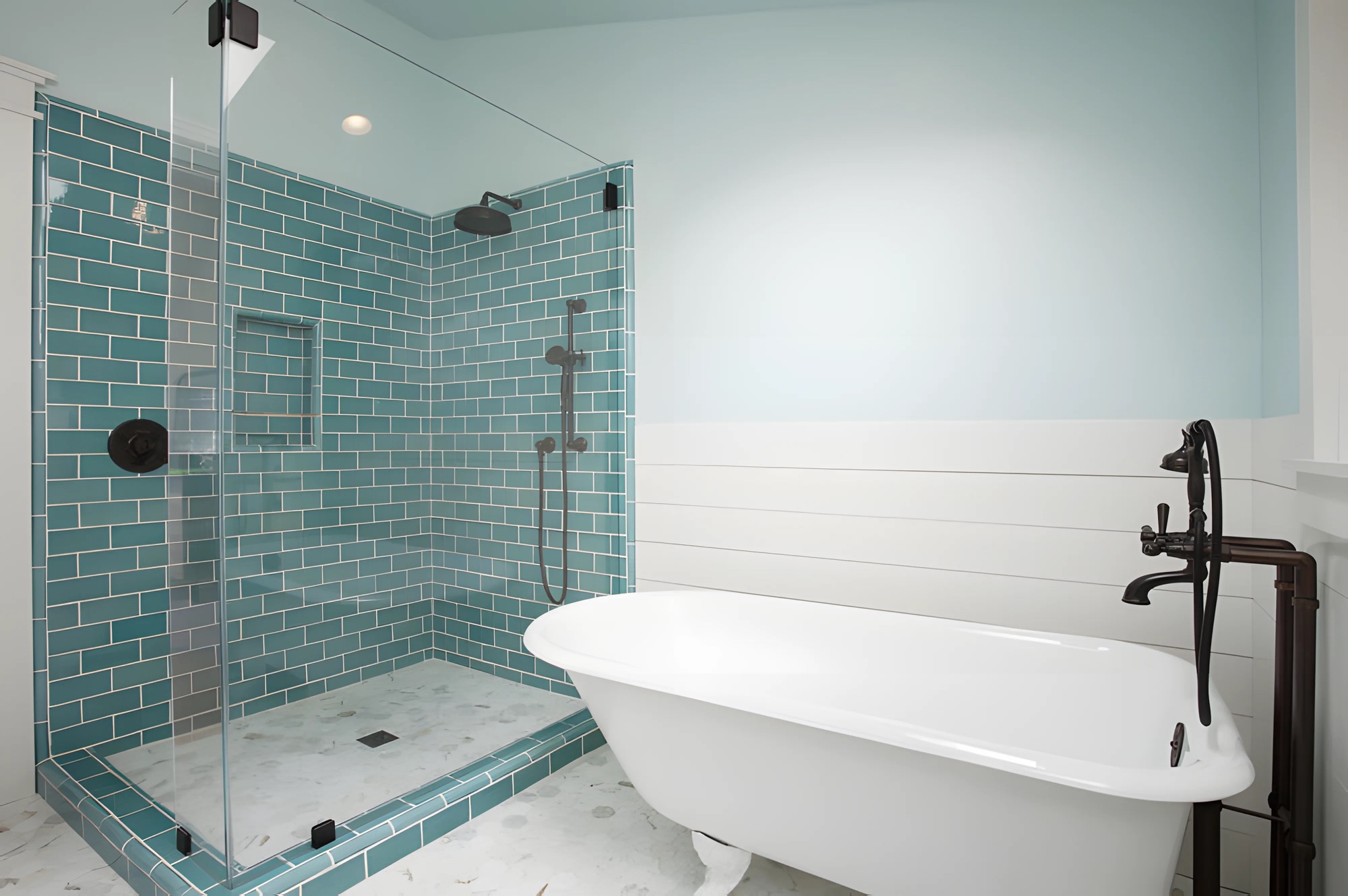 Blue tile bathroom with freestanding tub and glass shower by M2