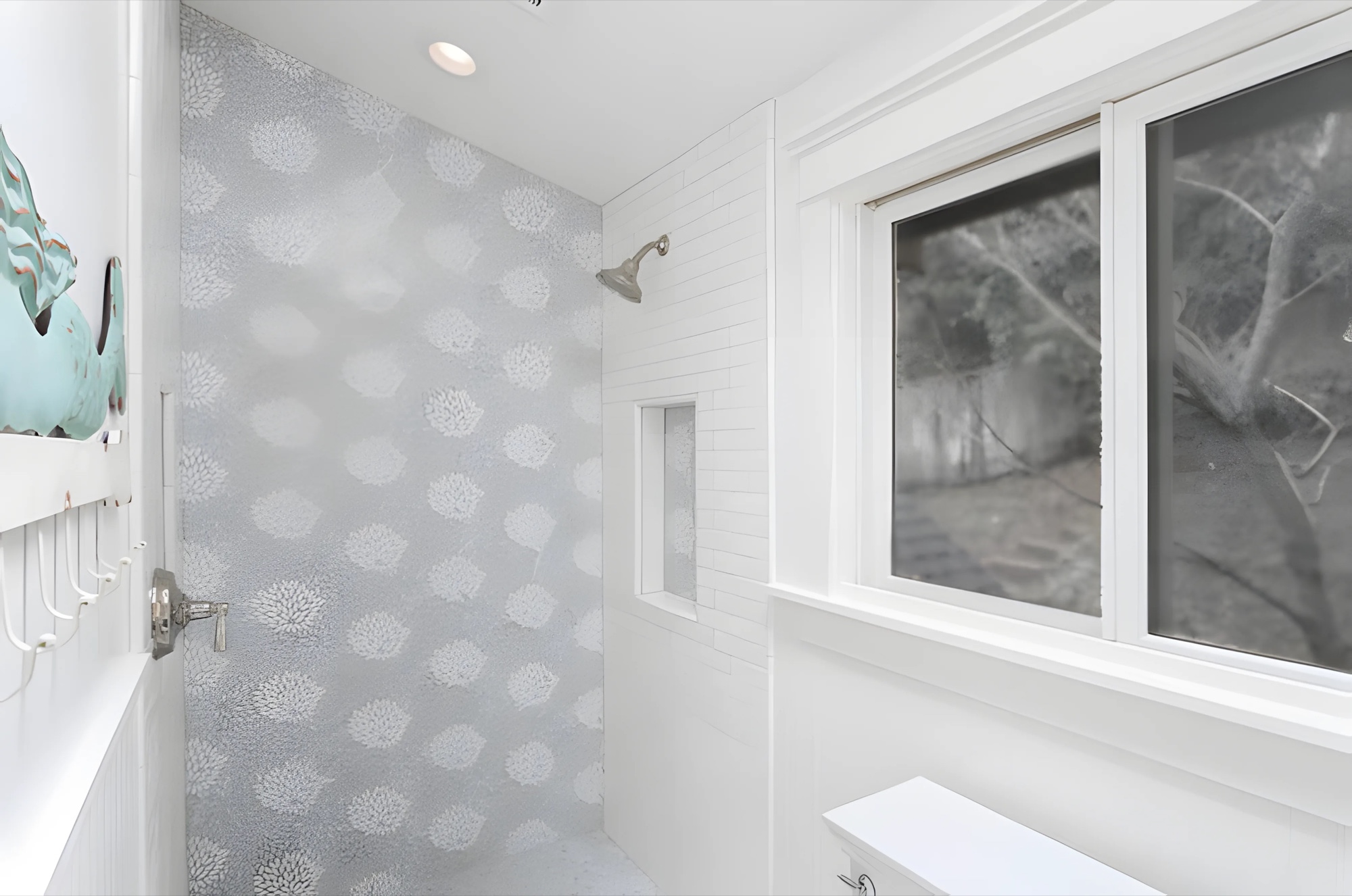 Walk-in shower with gray patterned wall tile, white subway tile, and a recessed niche by M2
