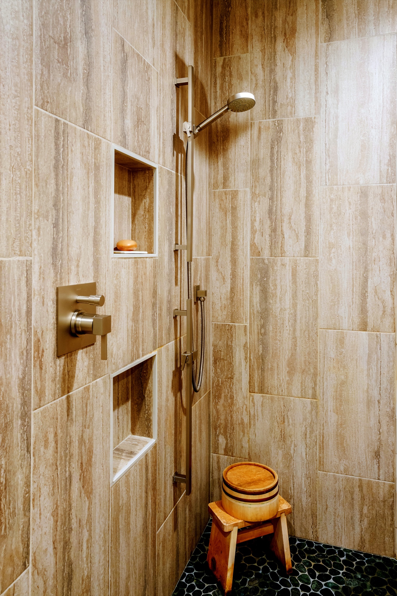 Stone shower with brass fixtures by M2