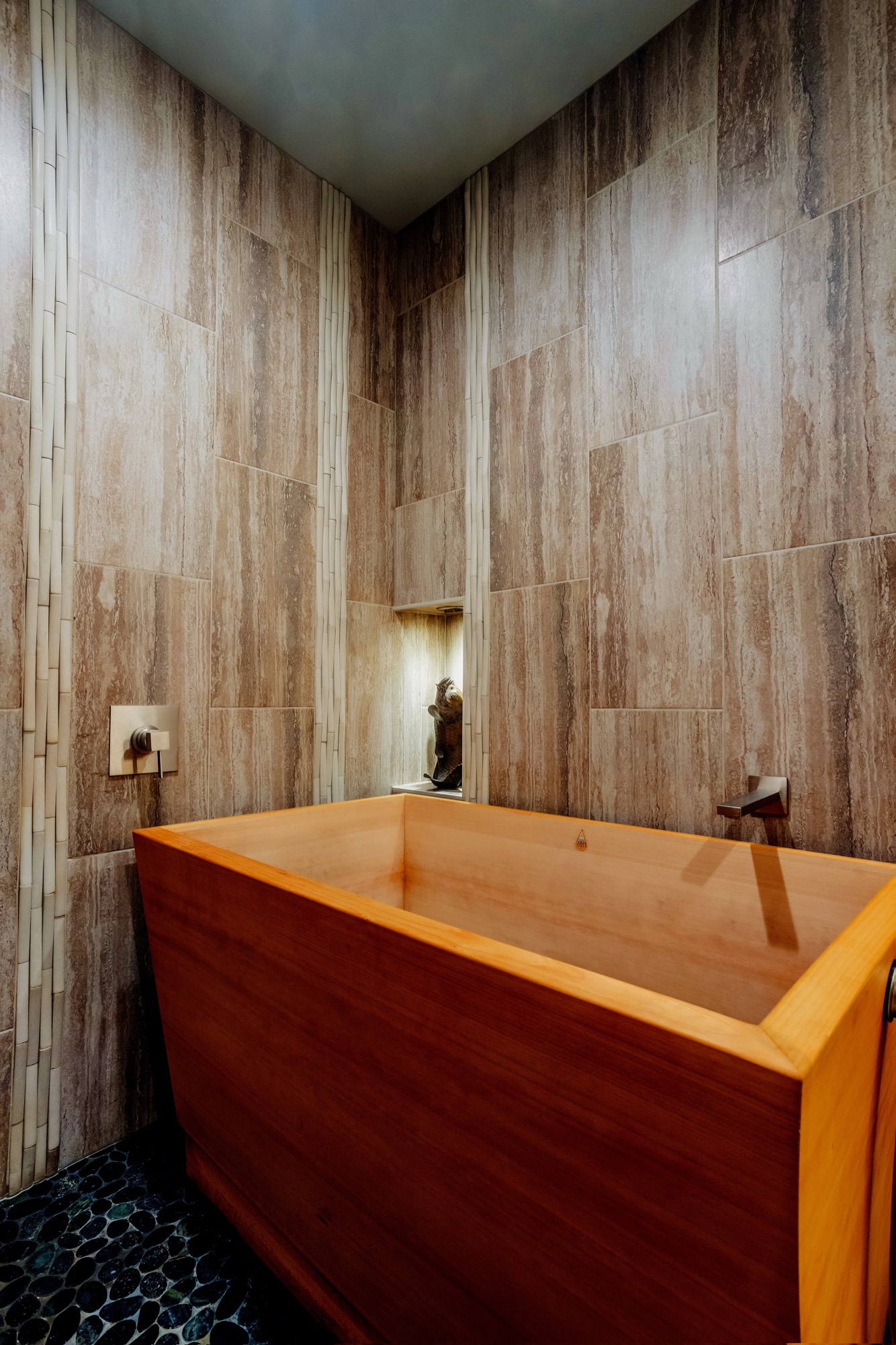 Wood soaking tub with stone wall finish by M2