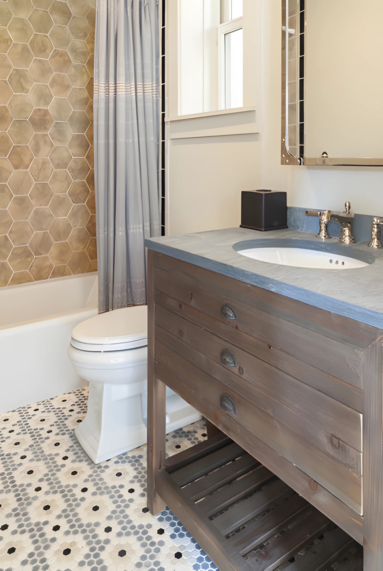Patterned bathroom with wood vanity and tile floor by M2