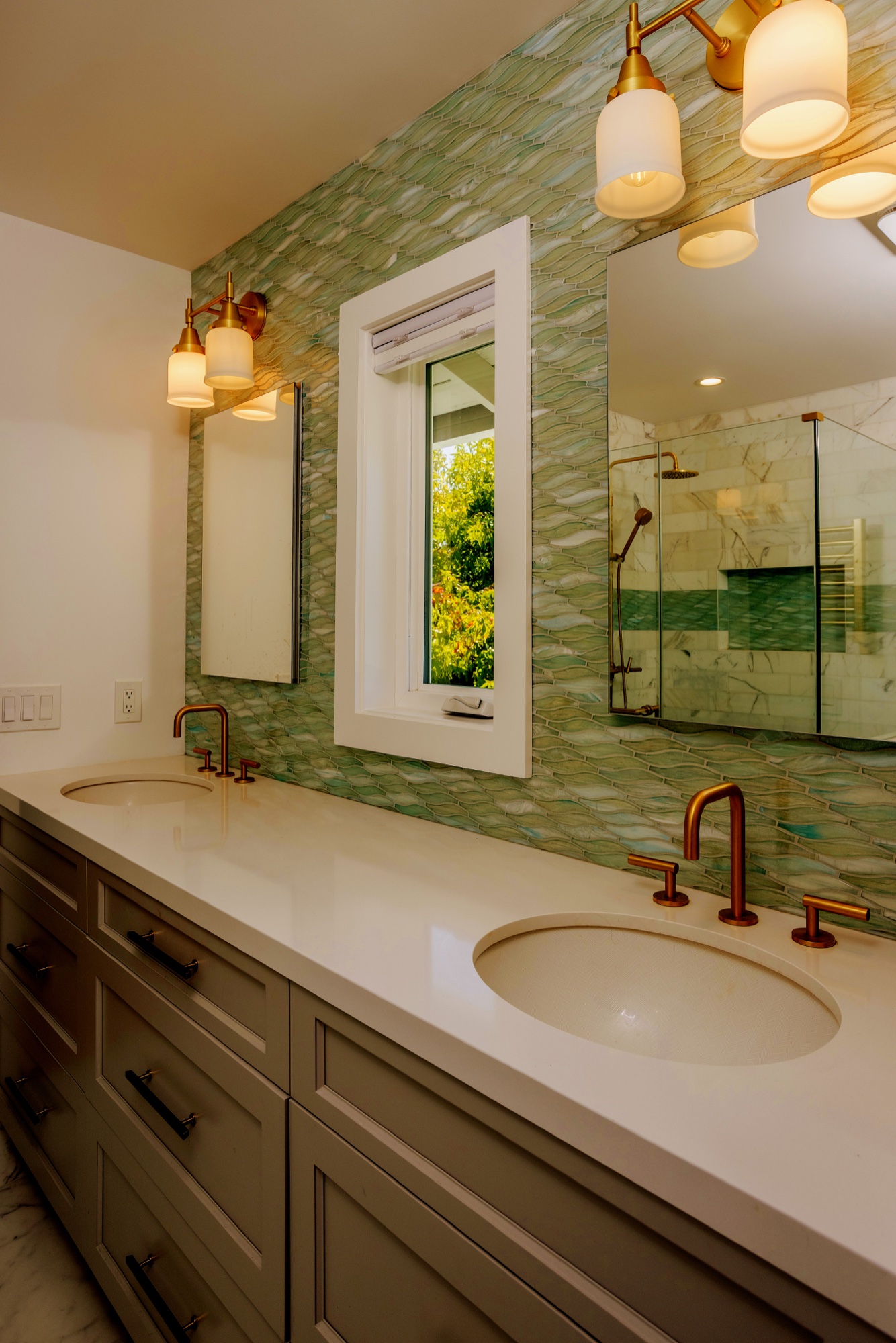 Bathroom vanity with green mirror and glass shower by M2