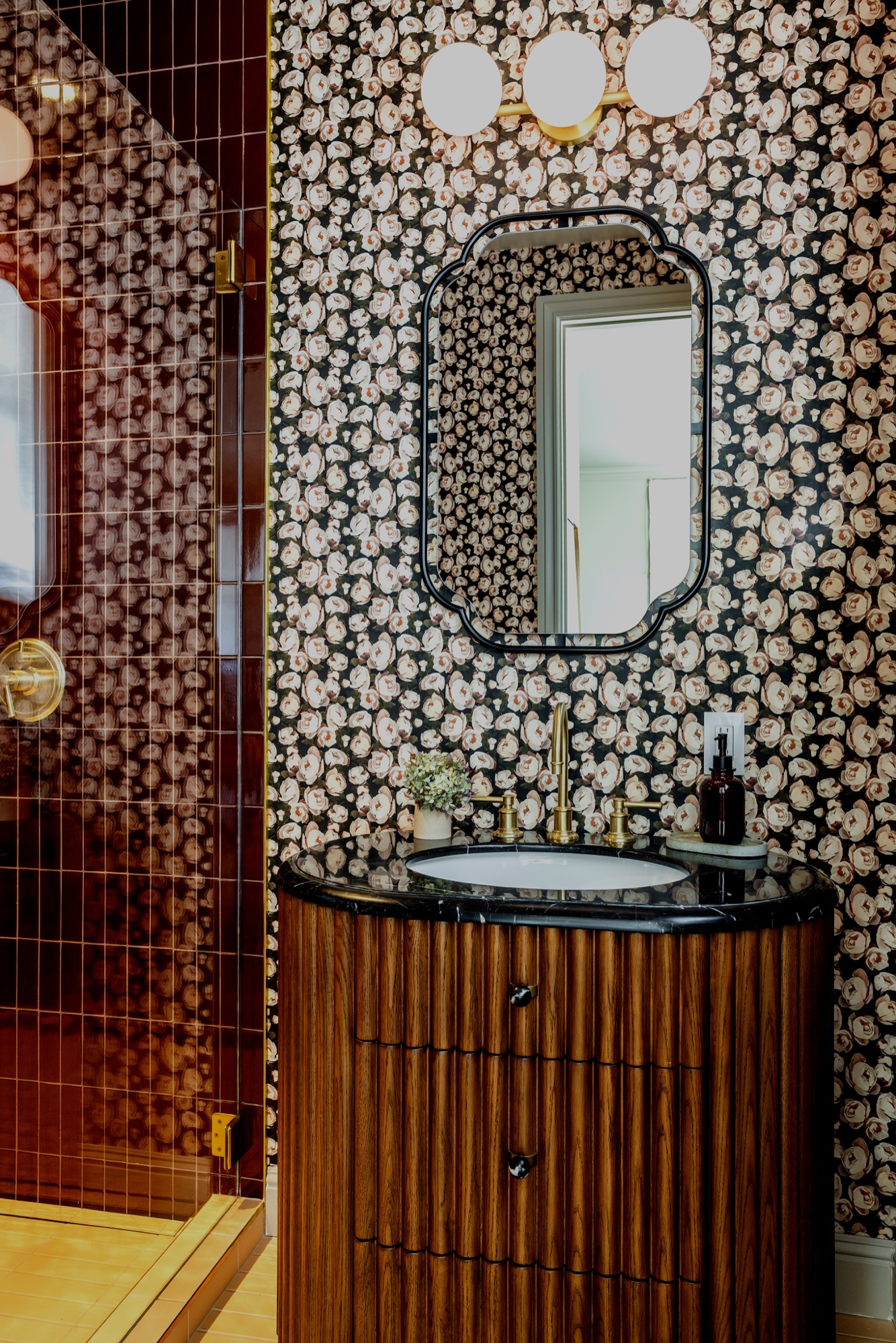 Dark bathroom vanity with patterned tile wall by M2