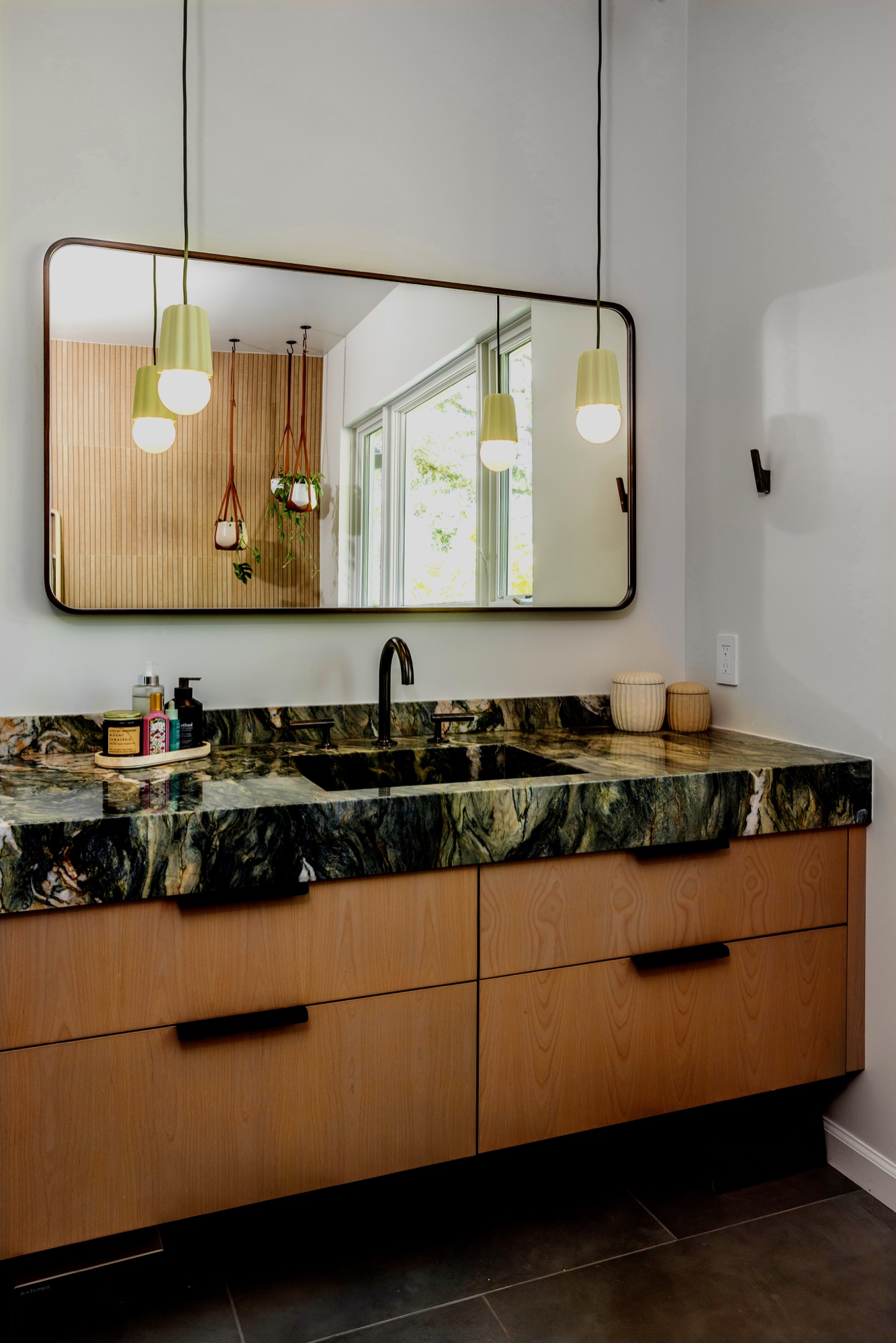 Primary bathroom vanity with mirror and stone counter by M2