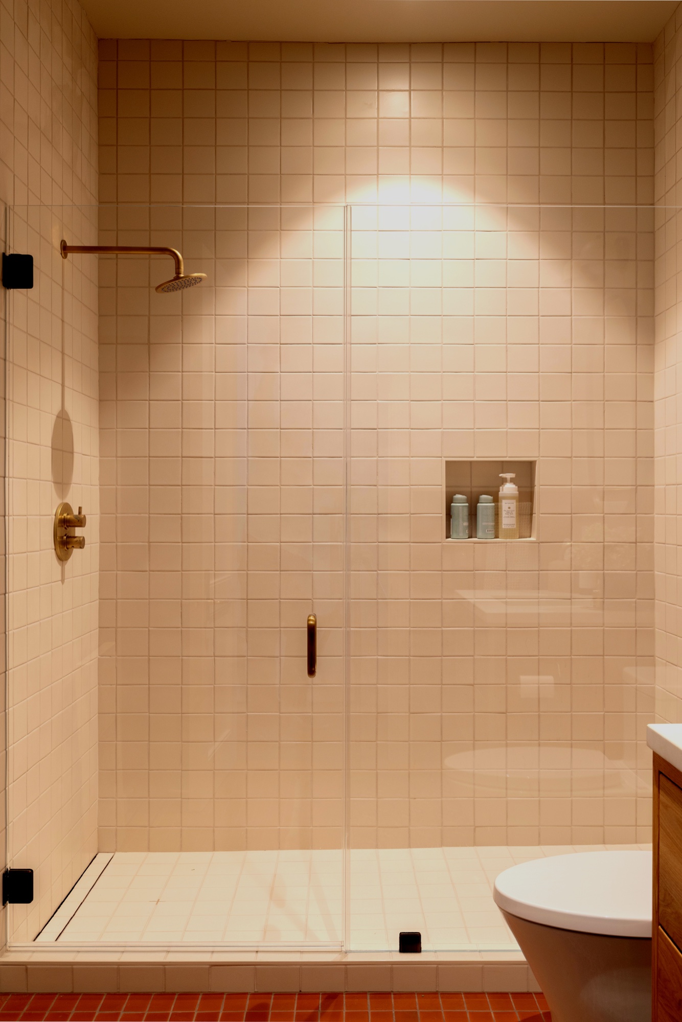White tiled shower with niche and glass door by M2