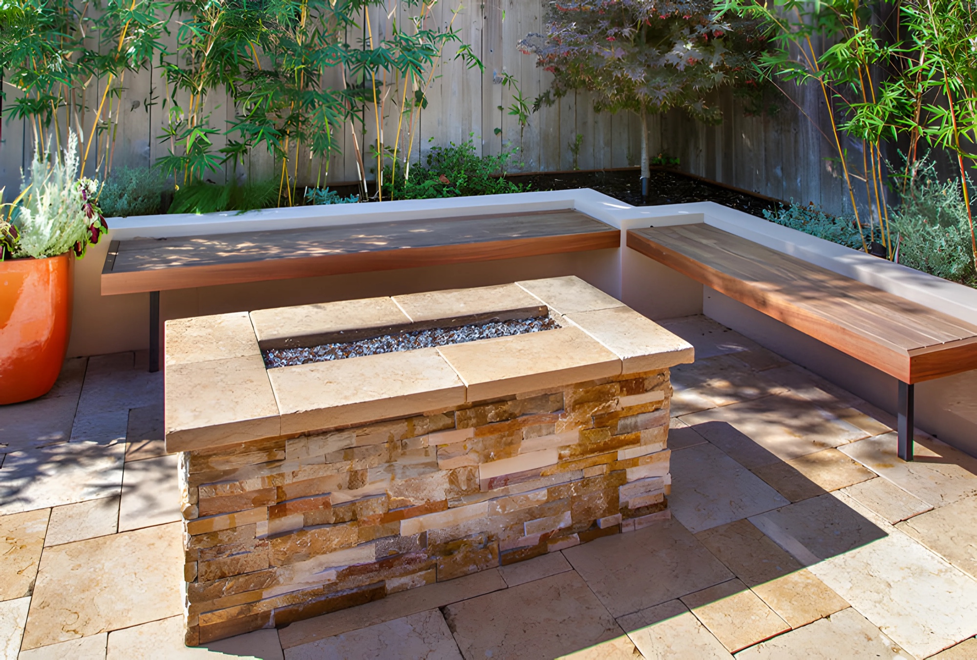 Stone fire table with wood-topped built-in bench seating